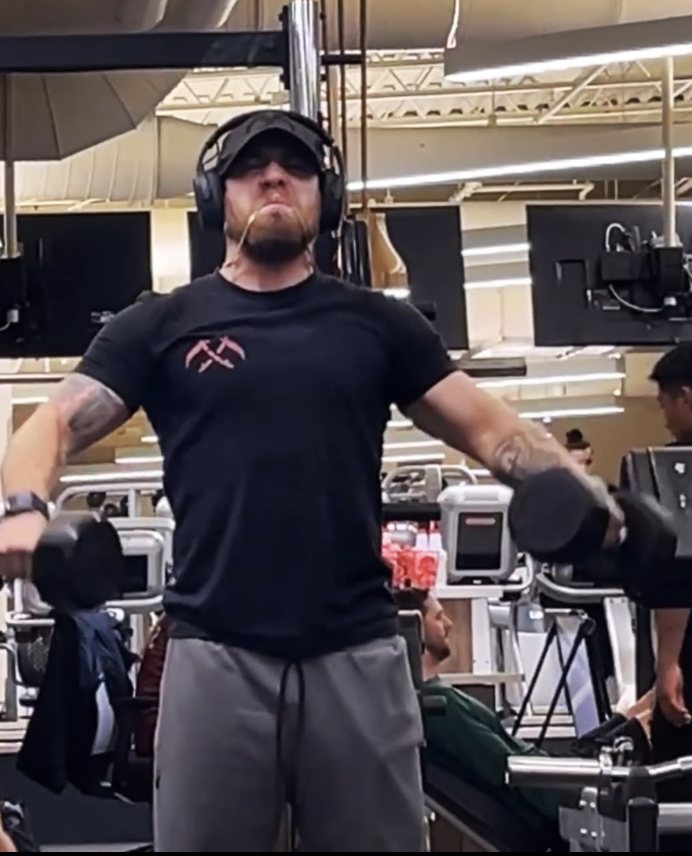 Ellis Page lifting weights at the gym on his comeback journey